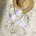 Women's white halter lace-up bikini swimsuit with briefs bottom for beach use