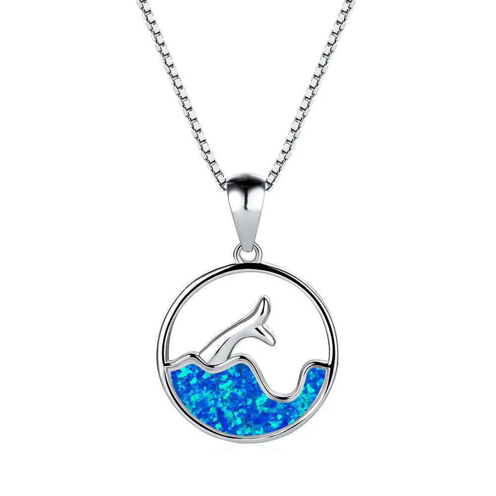 A woman's copper necklace with a round, geometric sea fishtail pendant in a blue opal colour finish.