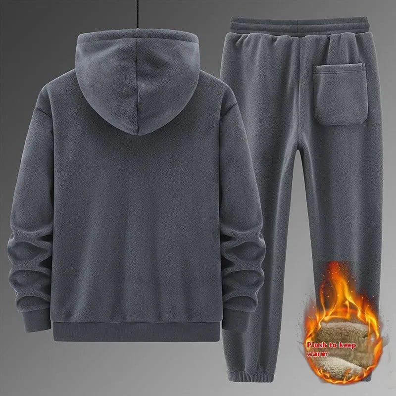 Grey hooded sweater and matching cotton trousers casual sport suit laid flat