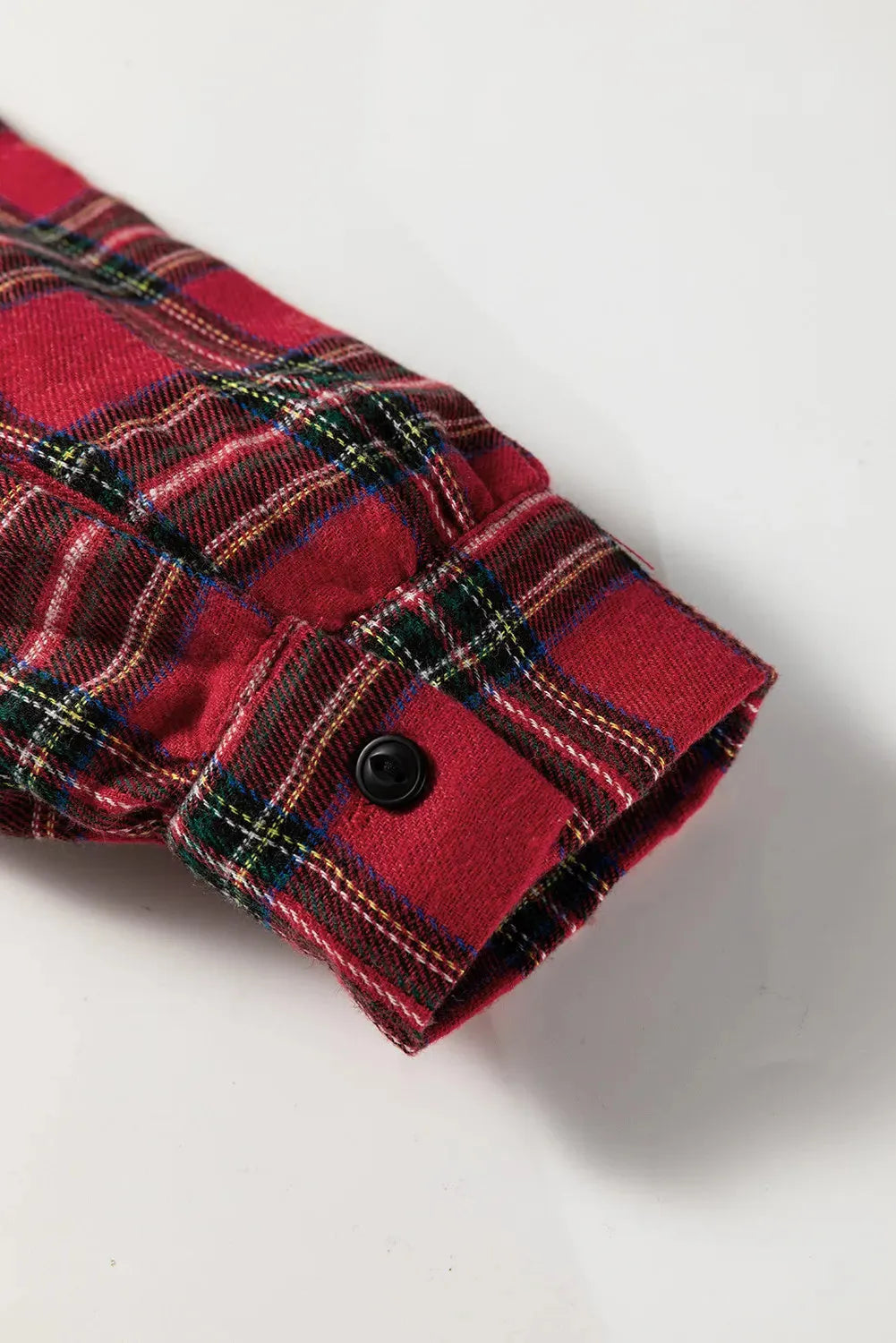Red plaid mini dress with shirt collar, long sleeves, half-button front, and ruffle hem