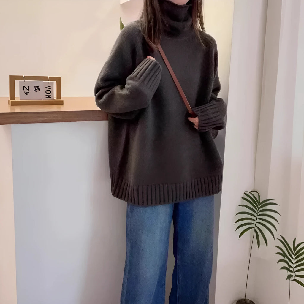 Red women's loose turtleneck sweater with a thick curling pile collar and a 3D pattern texture.