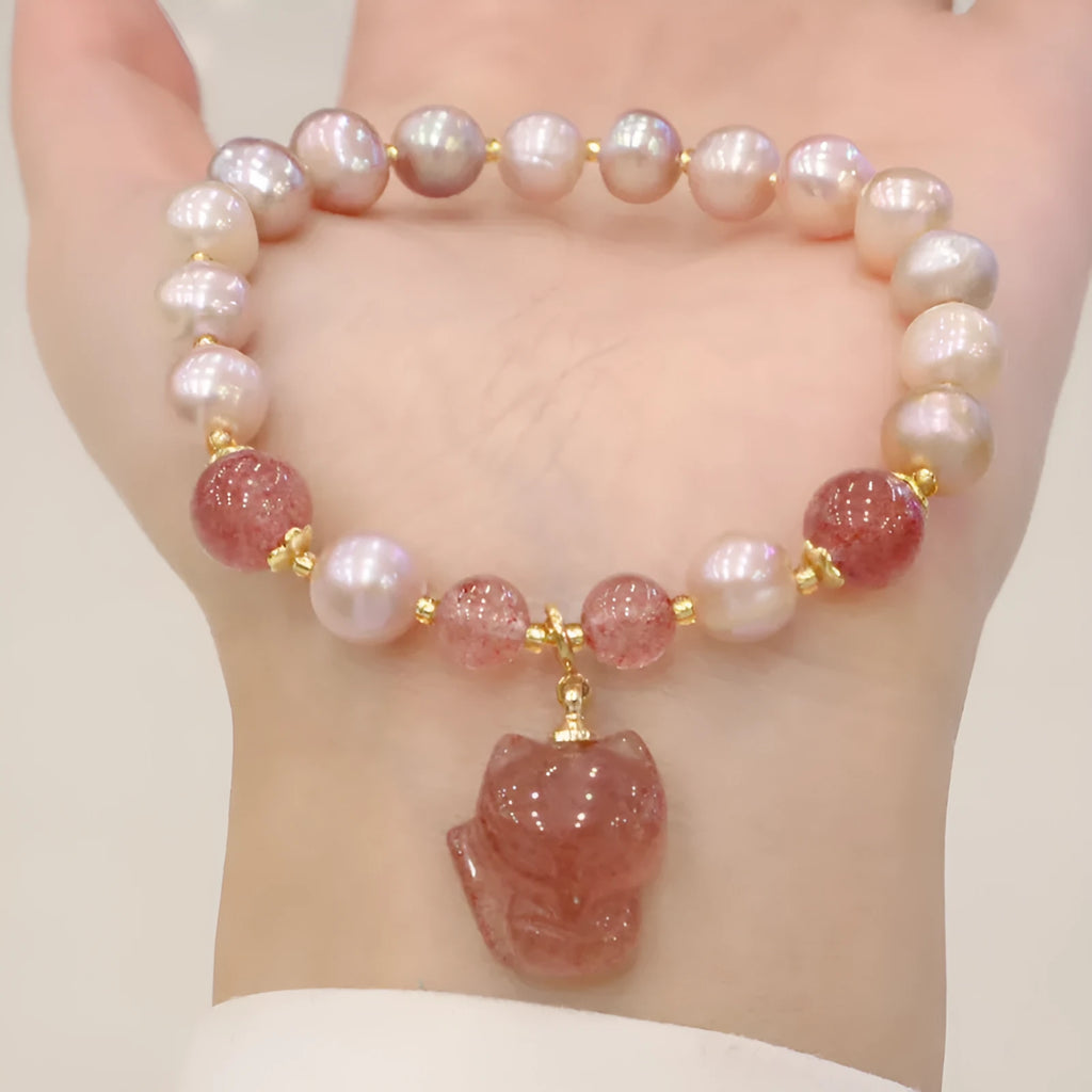 Light pink freshwater pearl bracelet with silver fox charm and strawberry quartz detail on adjustable strand