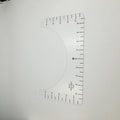 Transparent acrylic sewing ruler template for T-shirt patch alignment showing etched measurement markings