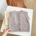 Children's knitted polka dot vest in apricot with single-breasted closure, featuring a sleeveless design for spring and autumn