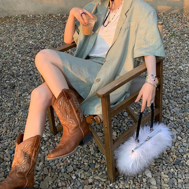 Brown women's embroidered mid-calf Martin boots with a low square heel and round toe.