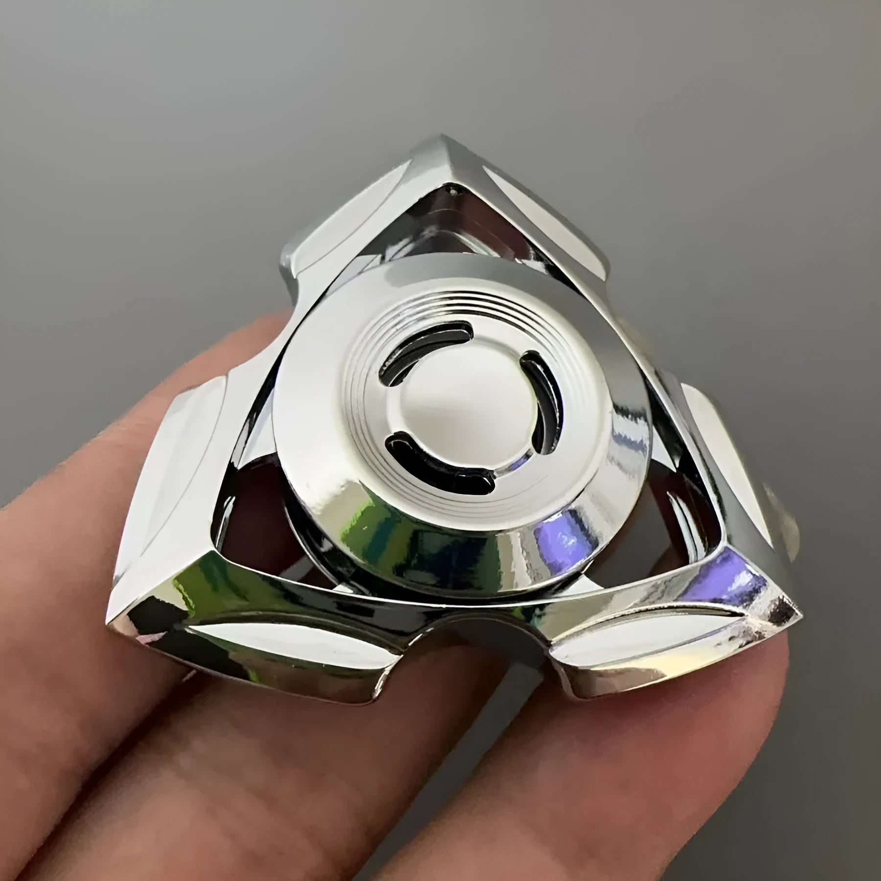 Silver and colourful alloy fingertip gyro decompression fidget toy.