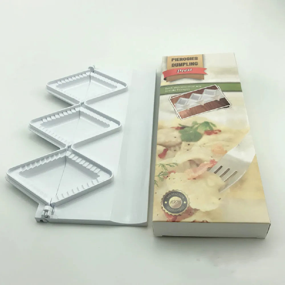 Pure white plastic dumpling maker 28.5 cm long on a kitchen countertop