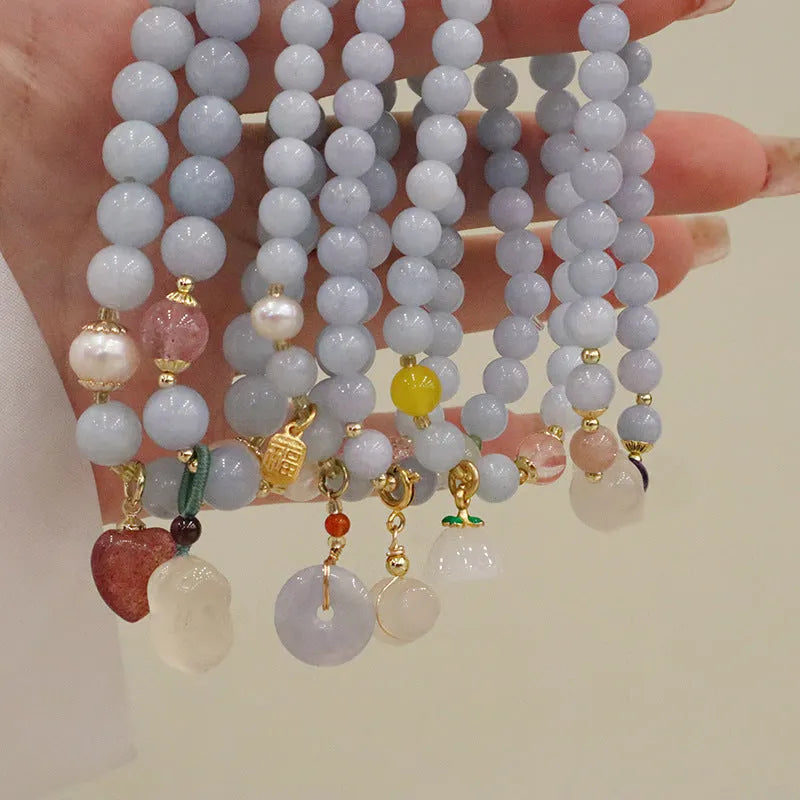 Aquamarine crystal bracelet with gold-plated climbing cat charm for women