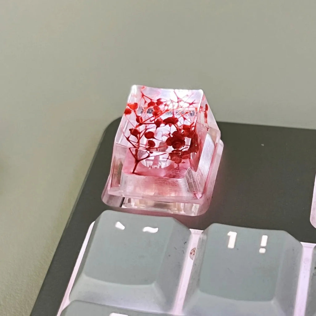 Transparent resin keycap with glitter particles creating starry night effect for mechanical keyboards
