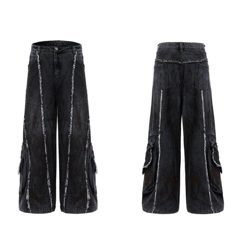 Black denim coat and trouser set with distressed raw edges and a splash-dye gradient pattern.
