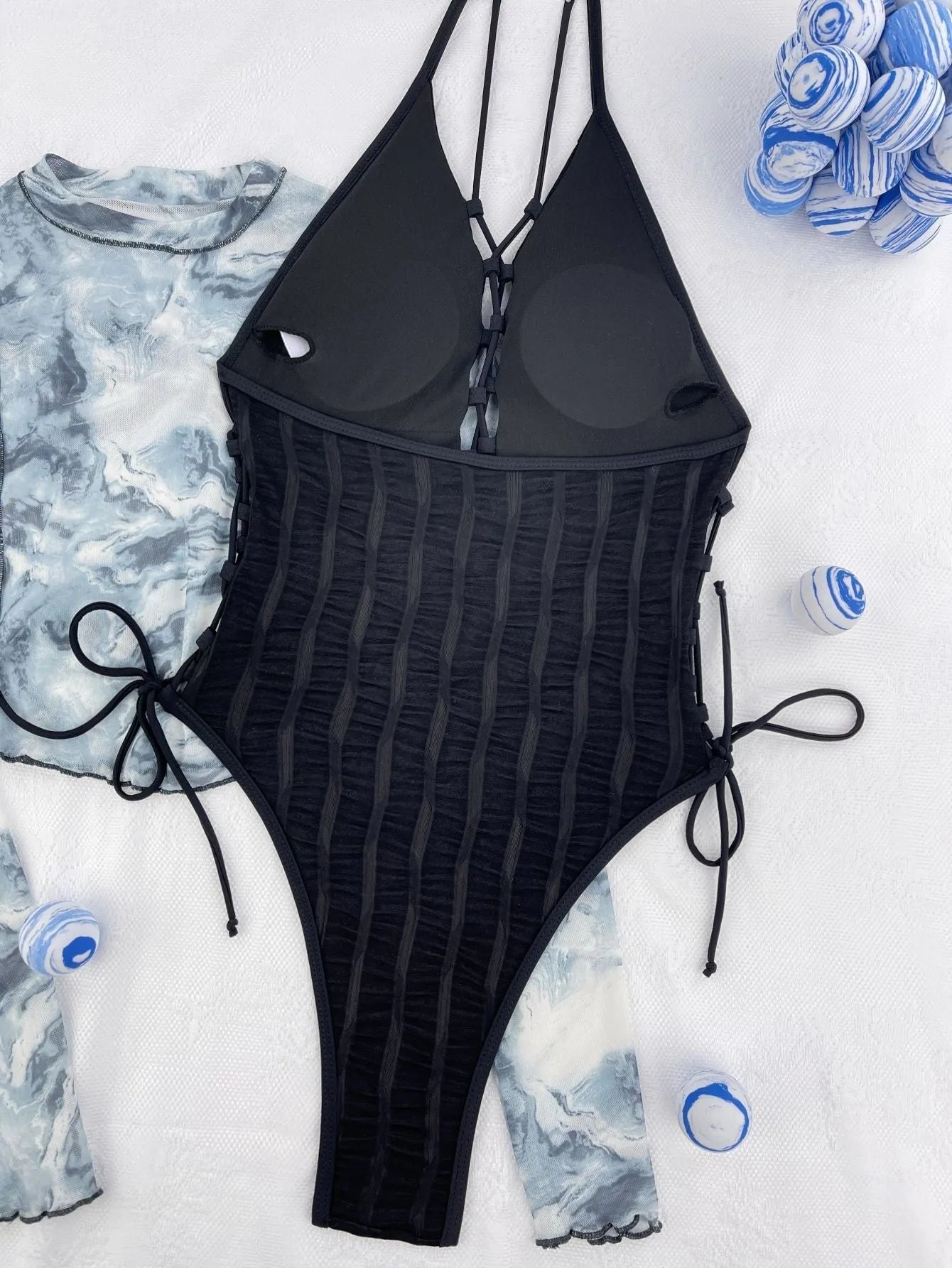 Black solid colour one-piece swimsuit for women shown flat