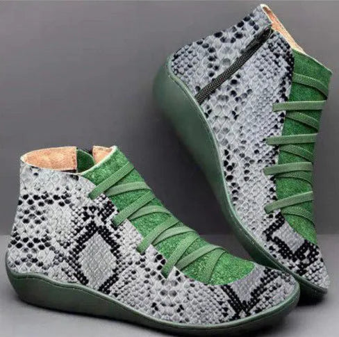 Women's black casual booties with round toe and low wedge heel on a rubber sole.