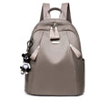 Medium square-shaped Oxford cloth rucksack in grey with double straps and a soft handle.