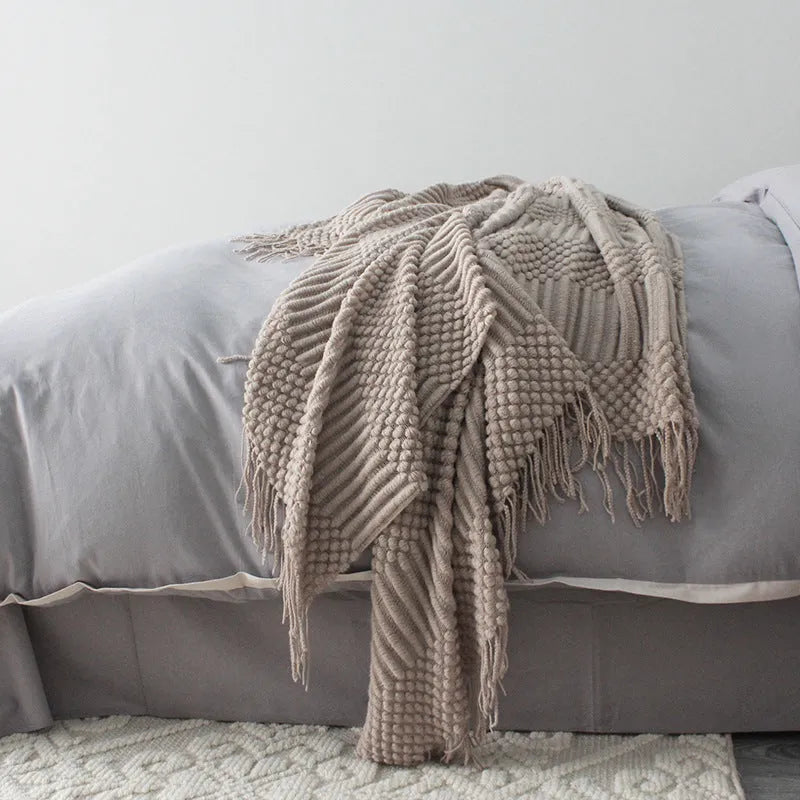Lightweight grey polyester fibre nap blanket folded to show size 127 by 170 cm.