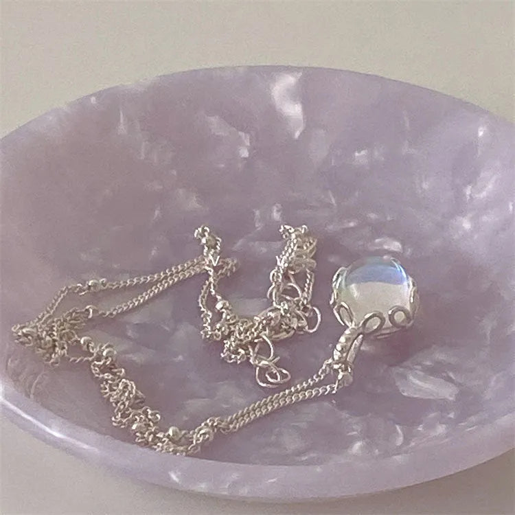 Silver geometric pendant on a sterling silver curb chain necklace for women.