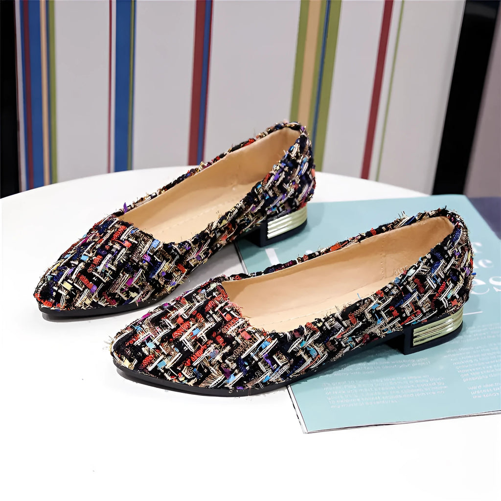 Women's black and white canvas flats with pointed toe and lace-up design