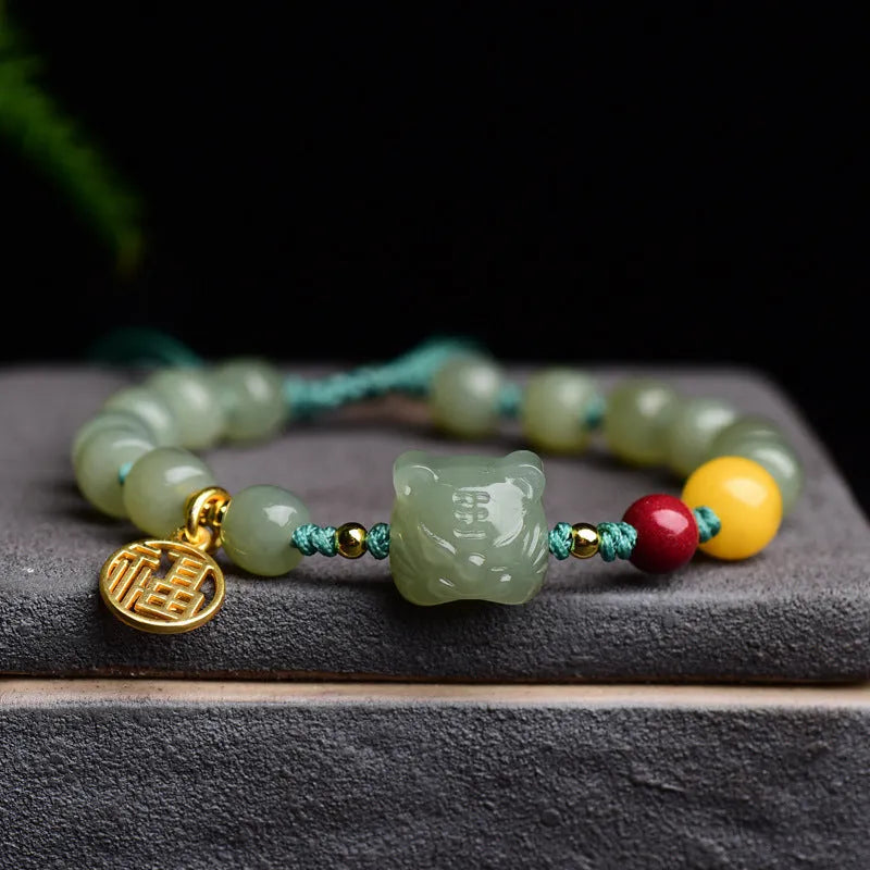 Natural Hetian jade bracelet with zodiac modelling, cinnabar and beeswax beads, and sequin detail.