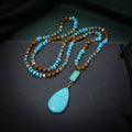 Turquoise heart-shaped water drop pendant necklace with blue gem inlaid detailing on geometric ball bead chain