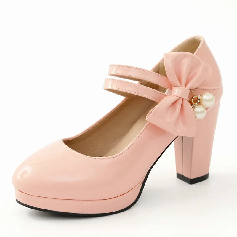 Women's red chunky heel platform shoes with round toe and buckle fastening on a rubber sole.