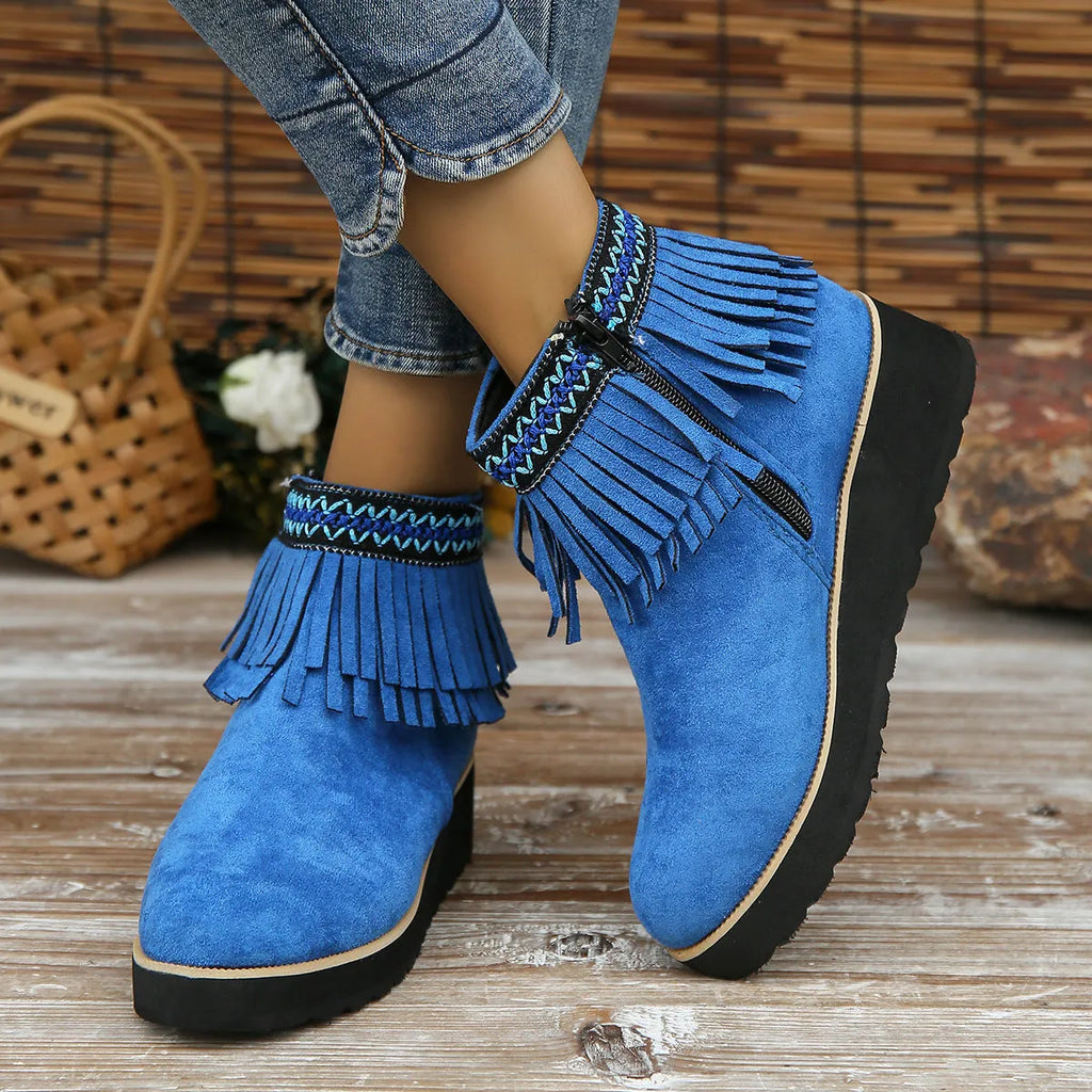 Women's dark brown suede wedge ankle boots with a side zipper and decorative tassels.