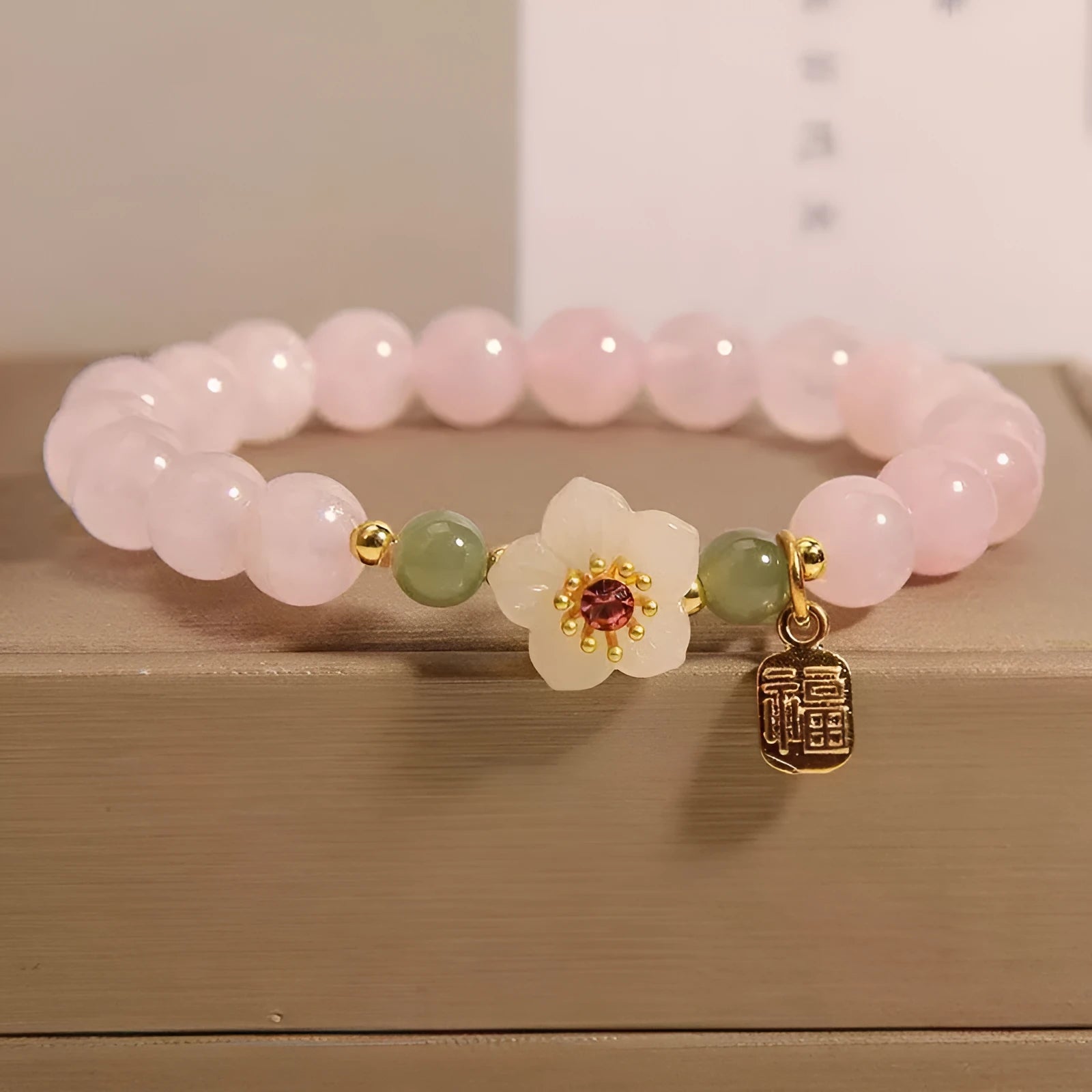 Crystal bracelet with peach blossom charms and polished Hetian jade beads in blessing card colours