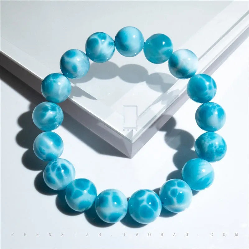 Blue Maillard style bodhi bracelet with natural crystal, sea-pattern stone, and pearls on a white background.