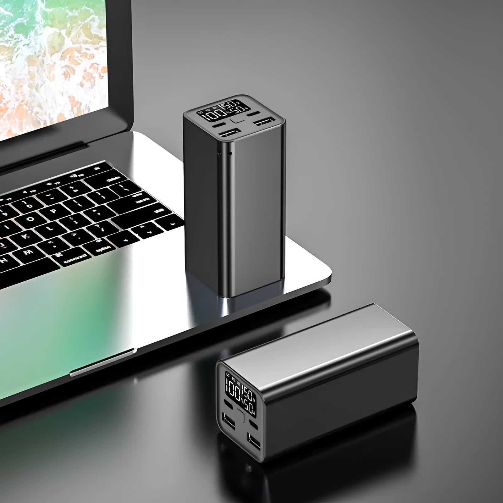 A black metal 65W laptop power bank with 20000mAh capacity, showing size compared to a hand.
