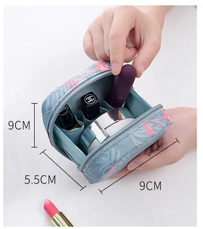 A blue cube-shaped cloth makeup storage bag sitting on a surface, open to show interior space.