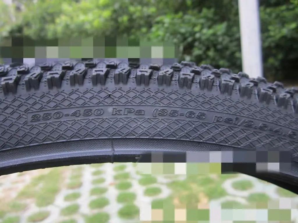 Ultralight mountain bike tyre with reinforced black sidewall shown next to size and weight specifications.