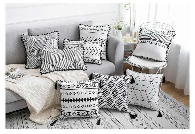 Bohemian national style throw pillow cushion cover in light grey on a sofa.