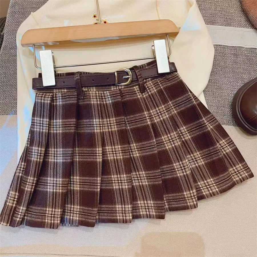 Girls red and black plaid A-line pleated skirt made from cotton blend fabric.