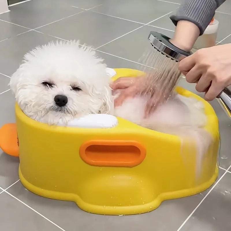 Blue duck-shaped PVC bath tub for washing dogs and cats on a patio.