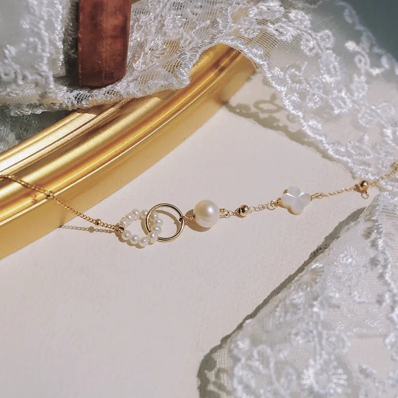 Women's natural pearl bracelet with 14k gold-plated setting.