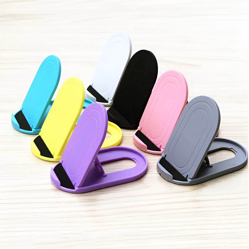 Adjustable plastic mobile phone stand in one of six colour options: black, blue, grey, pink, white, or yellow.
