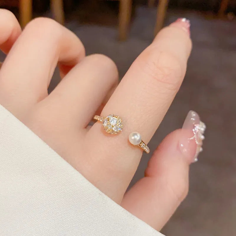 A simple geometric open-end ring with a round zircon stone, shown in gold and silver plated finishes.