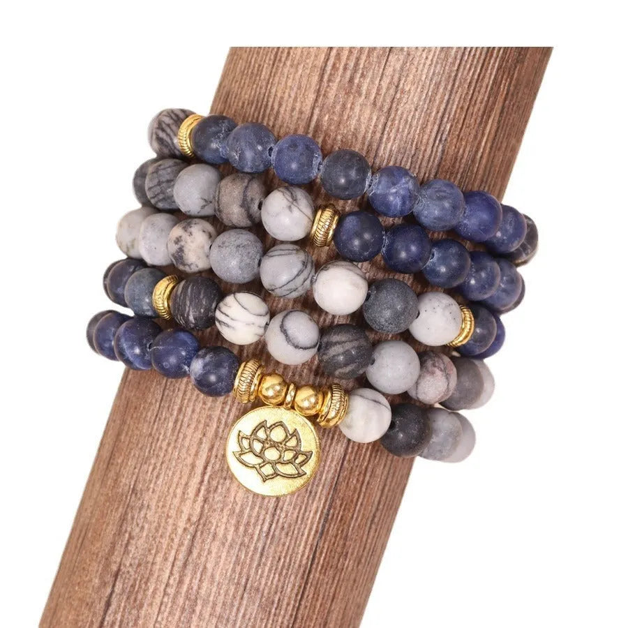 Blue patterned stone bead multi layer alloy bracelet with clasp on a white background.