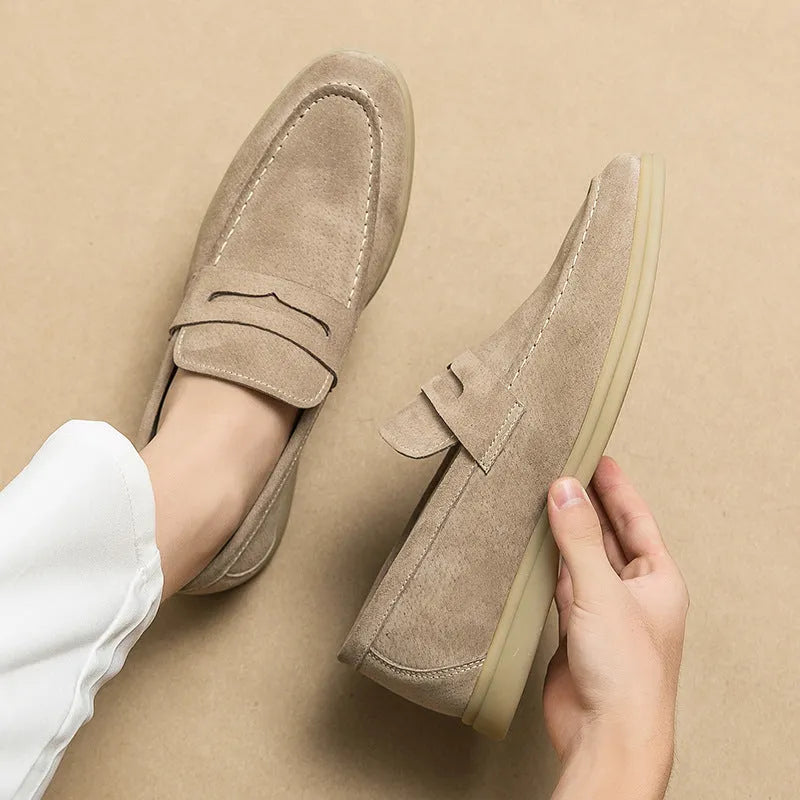 Men's beige leather slip-on casual shoes with round toe and rubber sole on a white background.