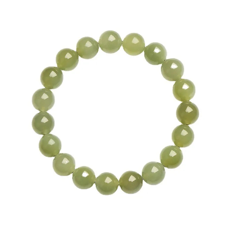 Unisex Hetian Jade ball bracelet with polished beads in clear colours on a wrist.