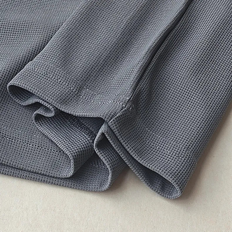 Men's dark grey heavyweight waffle-textured short-sleeved t-shirt on a hanger.
