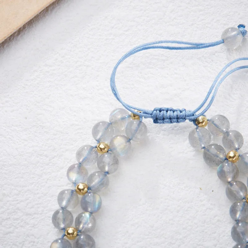 Gray moonstone woven bracelet with geometric design on woven hand rope