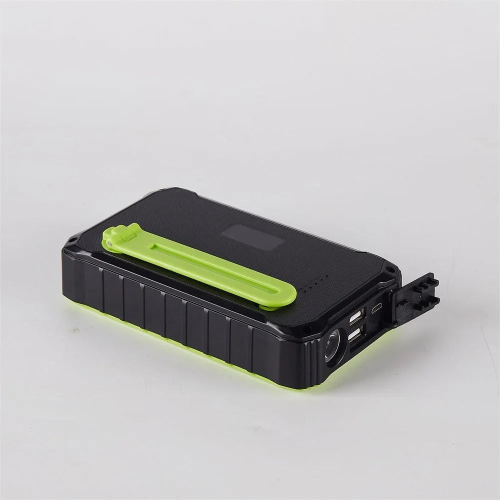 Orange portable solar power bank with hand crank and dual USB ports