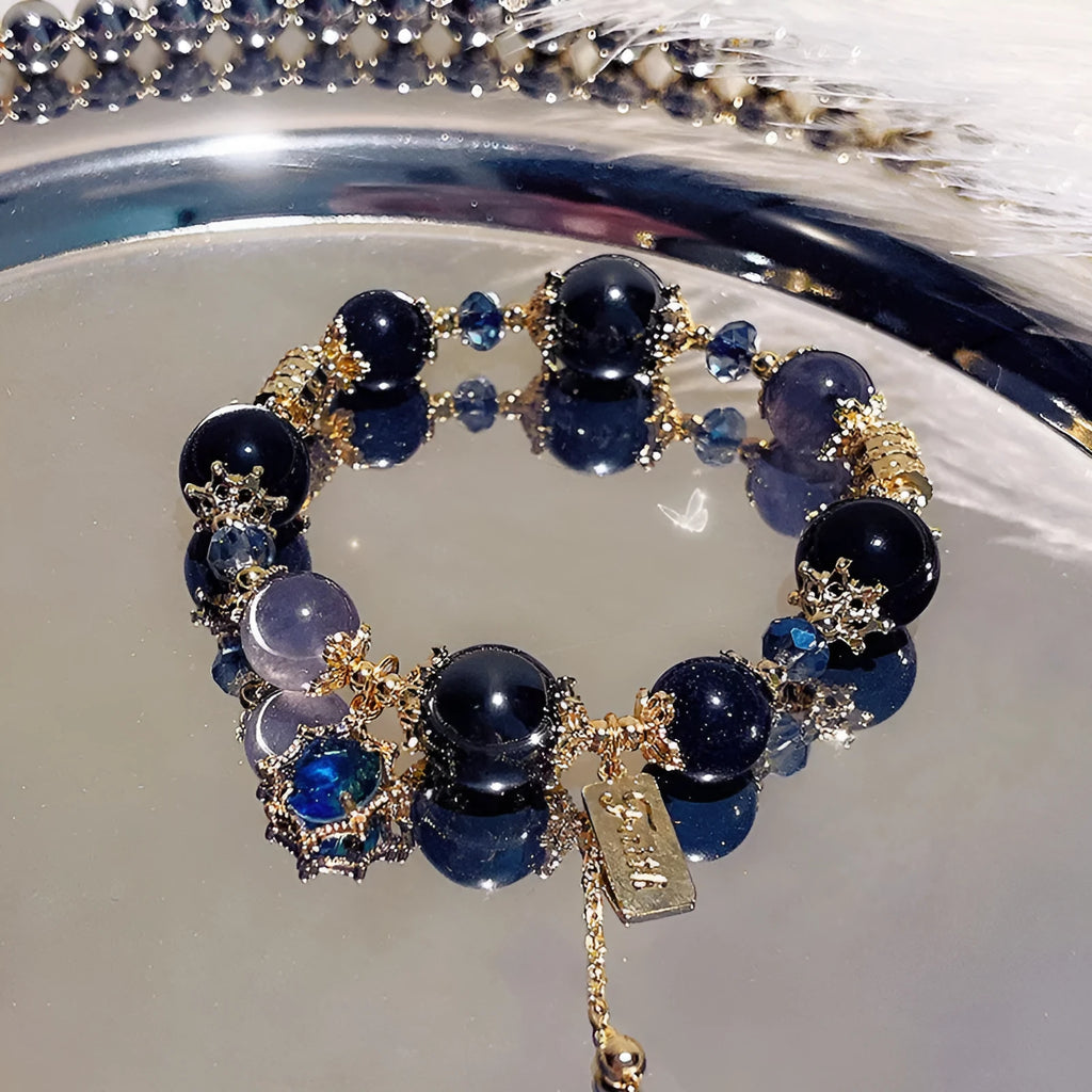 Women's galaxy-coloured alloy bracelet with a snowflake pendant and sweet bow design.