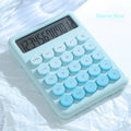 12-digit gradient colour desktop calculator in violet, blue, green, or pink on a desk
