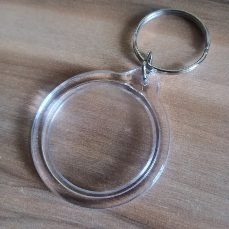 Transparent acrylic empty keychain shell in apple shape against a white background
