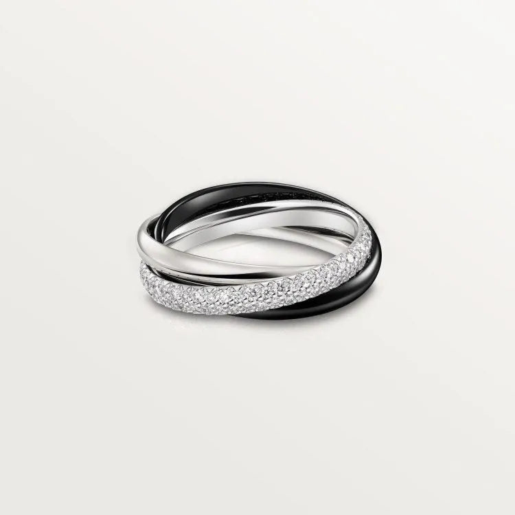 A set of two silver U-shaped geometric couple's rings, one with full diamonds and one plain, on a jewellery display.
