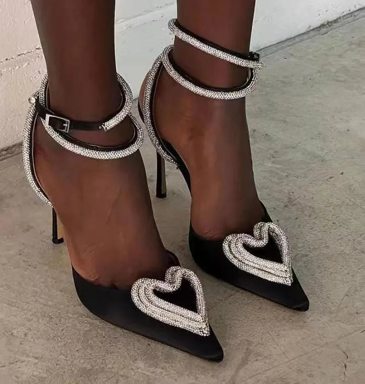 Women's pink satin sandal with heart rhinestone and adjustable ankle strap on a 9.5cm heel.