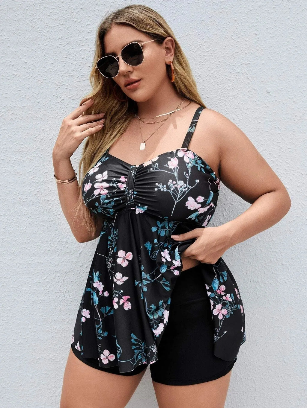 Women's floral print split colour one-piece swimsuit on a mannequin, showing front and back views.
