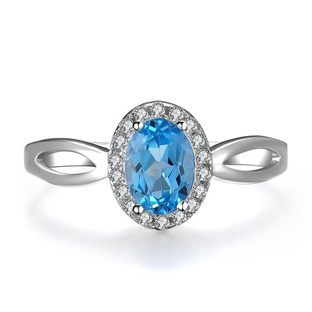 925 sterling silver four-piece jewellery set with blue topaz gems showing geometric-designed earrings, ring, pendant, and necklace
