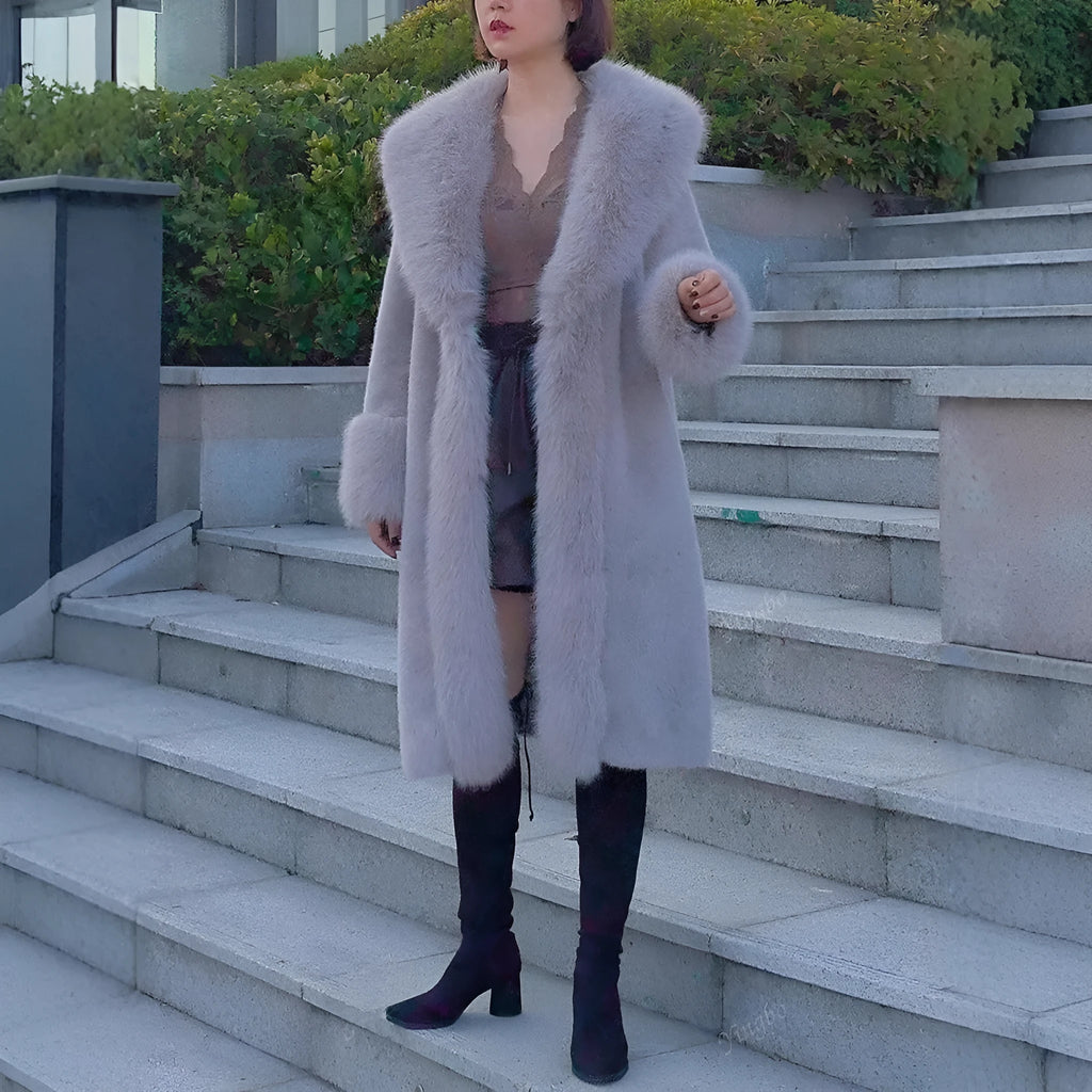 A grey women's mid-length leather coat with thick faux rabbit fur trim and collar.