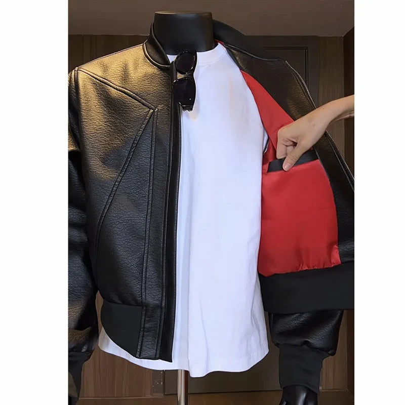 Man wearing a black slim-fit PU leather jacket with litchi grain texture and extended length.